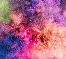Colorful powder bursting up, creating exploding texture. photo