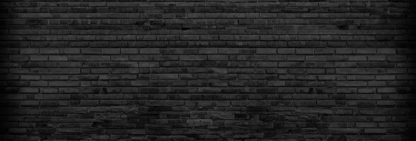 Textured Panoramic Background of Unplastered Black Brick Wall in Empty Basement photo