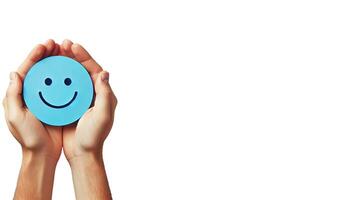 A pair of hands gently holding a blue circle with a simple, happy face drawn on it on white background photo