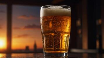 Cold beer with foam in a glass on the table in a restaurant at night photo