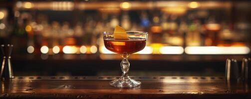 A Single Cocktail With Orange Twist on a Bar Countertop photo