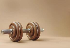 Single Black Dumbbell On A Beige Background photo
