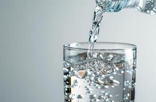 Pouring Water From A Bottle Into A Glass photo