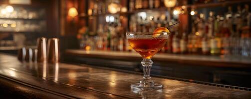 A Single Cocktail on a Bar Counter in a Dimly Lit Bar photo