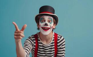 Smiling Clown In Striped Shirt And Hat Gesturing With Both Hands In Front Of Blue Background photo
