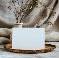 Blank White Card Mockup on Wooden Tray With Dried Flower Arrangement photo