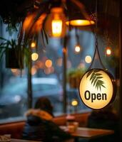 Open Sign Hanging in a Restaurant Window at Night photo