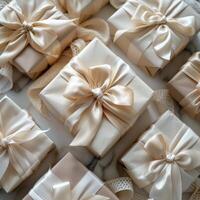 Beige Gift Boxes With Ivory Satin Ribbons Arranged on a Textured Surface photo