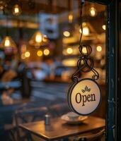 Open Sign Hanging in a Restaurant Window at Night photo