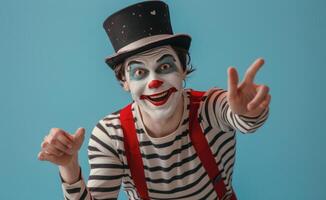 Smiling Clown In Striped Shirt And Hat Gesturing With Both Hands In Front Of Blue Background photo
