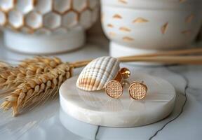 Gold Round Diamond Stud Earrings on White Marble Tray With Seashell and Wheat photo