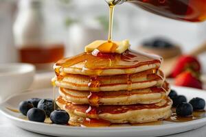 A Stack of Golden Brown Pancakes Drizzled With Syrup and Topped With Butter photo