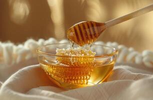 Dripping Honeycomb in Glass Bowl on White Fabric photo
