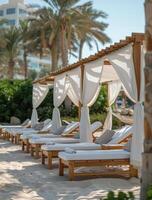 White Canopy Loungers by the Poolside on a Sunny Day photo