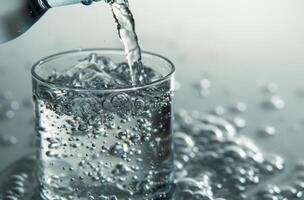 Pouring Water From A Bottle Into A Glass photo