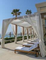 White Canopy Loungers by the Poolside on a Sunny Day photo