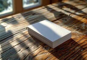 White Card Deck on Rustic Wooden Table With Sunbeam photo