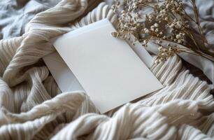 Blank White Envelope on Knit Fabric With Dried Flowers photo