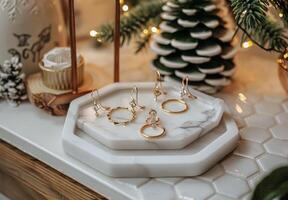 White Marble Tray With Gold Rings and Dried Eucalyptus Branch on Hexagonal Tiles photo