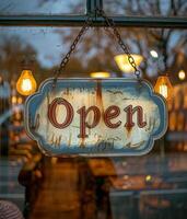 Rusty Open Sign Hanging in a Shop Window at Dusk photo