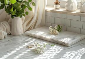 White Marble Tray With Gold Rings and Dried Eucalyptus Branch on Hexagonal Tiles photo
