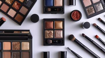 Assortment of Black Compact Makeup Products Arranged on a White Surface photo