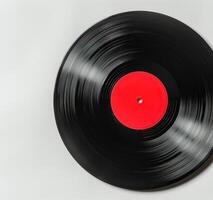Black Vinyl Record With Red Label On White Background photo
