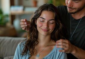 Woman With Curly Hair Receiving a Gentle Hair Massage From a Man in a Living Room photo