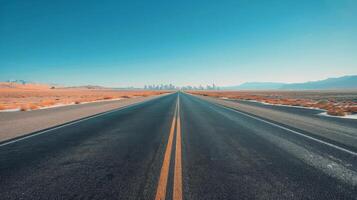 Empty Road Leading Towards A City Skyline During Sunrise photo