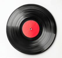 A Worn Vinyl Record With A Red Label On A White Background photo