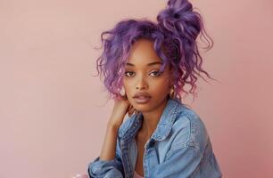 Young Woman With Purple Hair in Front of a Pink Background photo