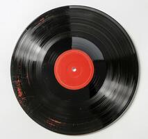 A Worn Vinyl Record With A Red Label On A White Background photo