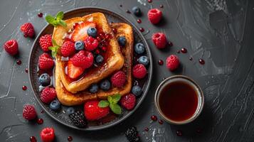 Plate of French Toast With Berries and Syrup photo