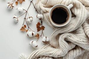 Warm Beverage With Cotton Branches and Knitted Blanket on White Surface photo