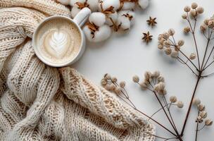 Warm Beverage With Cotton Branches and Knitted Blanket on White Surface photo