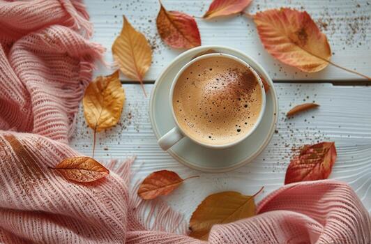 Warm Latte With Autumn Leaves and Blanket on White Wooden Table photo