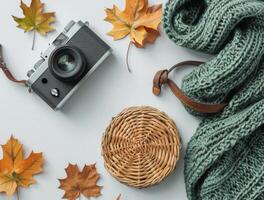 Autumnal Flat Lay With Camera, Knitted Scarf, and Wicker Baskets photo