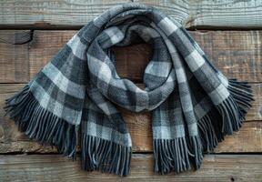 Black And White Plaid Scarf With Tassels On Rustic Wood photo