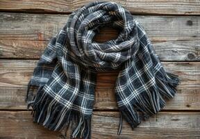 Black And White Plaid Scarf With Tassels On Rustic Wood photo