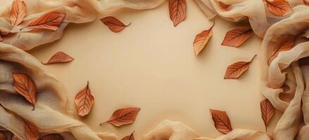 Dried Autumn Leaves and Burlap Fabric on White Background photo