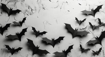Black Paper Bats Decorated on a Cracked White Wall photo