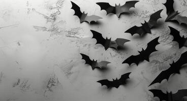 Black Paper Bats Decorated on a Cracked White Wall photo