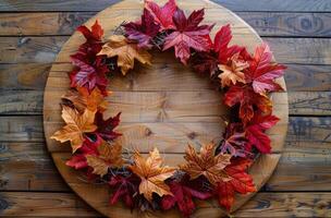 Colorful Autumn Leaves and Berries Framing a Wooden Background photo