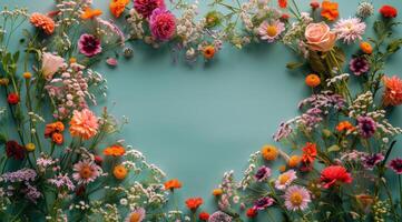Colorful Wildflowers Arranged In Heart Shape On Blue Background photo