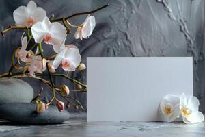White Orchid Flowers and Blank Card on Grey Background photo