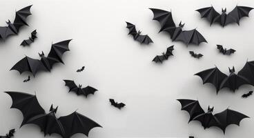 Black Paper Bat Silhouettes Against White Background photo