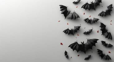 Black Paper Bat Silhouettes Against White Background photo