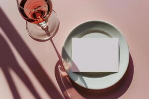 Glass of Water and White Card on Plate With Palm Leaf Shadows photo