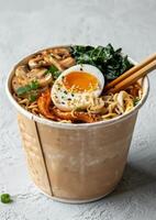 Delicious Takeout Noodle Soup With Egg, Mushrooms, and Green Onions photo
