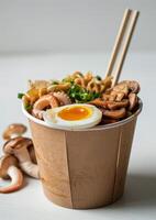 Delicious Takeout Noodle Soup With Egg, Mushrooms, and Green Onions photo